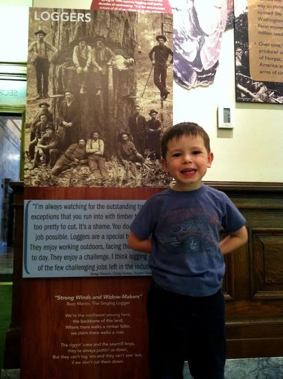 Max, standing next to a quote from his paternal Great-Grandfather in an exhibit at my office